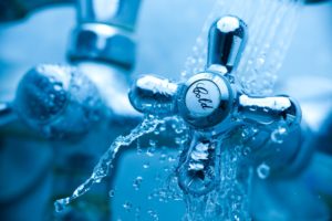 Bath tap with cold sign close up